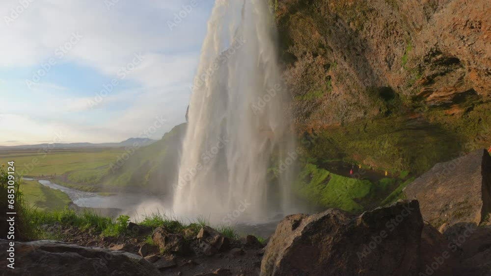 DOLLY SLOW MO SHOT - The Seljalandsfoss waterfall on the south coast of Iceland bathed in the otherworldly light of the midnight sun. The waterfall drops 60 meters and is part of the Seljalands River. DOLLY SLOW MO SHOT - The Seljalandsfoss waterfall on the south coast of Iceland bathed in the otherworldly light of the midnight sun. The waterfall drops 60 meters and is part of the Seljalands River.