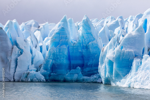 Blue Ice on a glacier shaped in a form of letter M photo