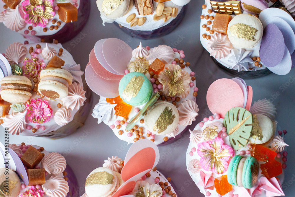 Beautiful traditional Orthodox Easter cakes decorated with glaze, meringues, chocolate, nuts, toffees, macaroons, flowers and jelly