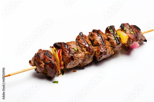Delicious skewered kebab with a mix of marinated meats, vegetables, isolated on white background.