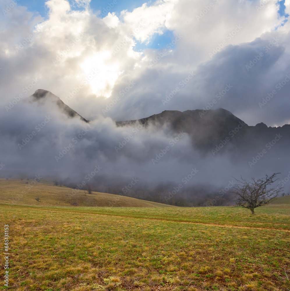 mountain plateau in dense mist and clouds