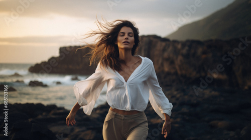 Wallpaper Mural Beautiful young woman in a white shirt and beige pants running on the beach at sunset. Torontodigital.ca