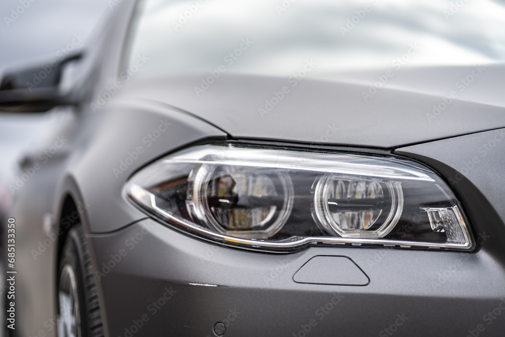 headlight front of modern prestigious car closeup - obrazy, fototapety, plakaty 
