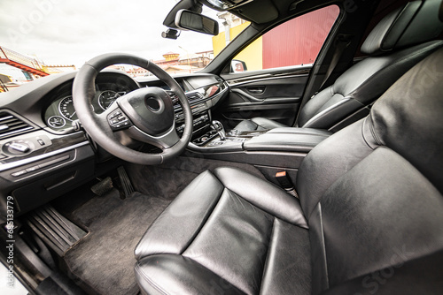 Car inside. Interior of prestige modern car. Comfortable leather seats. Black cockpit with on isolated white background.