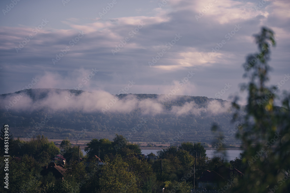 Obraz premium Low rain clouds in misty forest. The lifting of the fog at dawn. The water cycle in nature