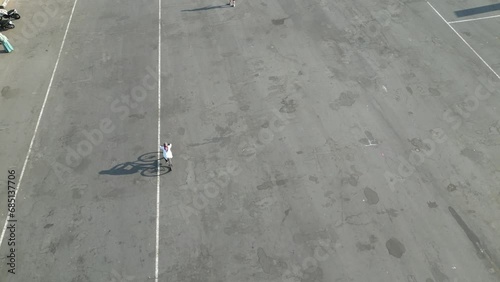 Aerial View of Football Stadion Maguwoharjo. People were jogging, skating and cycling along the track in the morning. 4k Video footage. photo