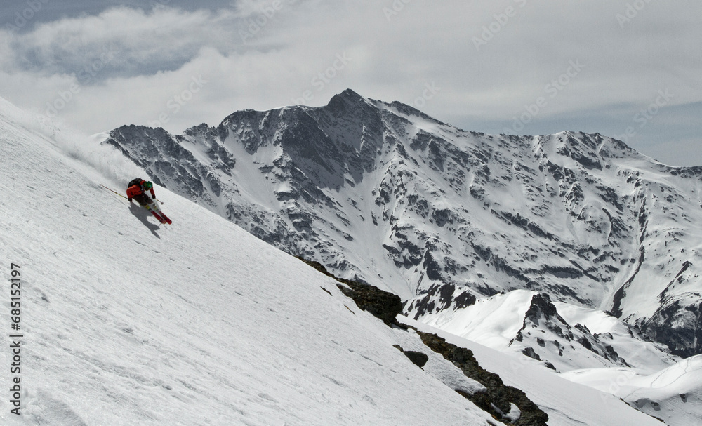Anonymous person skiing on snowy mountain at Swiss Alps on sunny day Anonymous person skiing on snowy mountain at Swiss Alps on sunny day