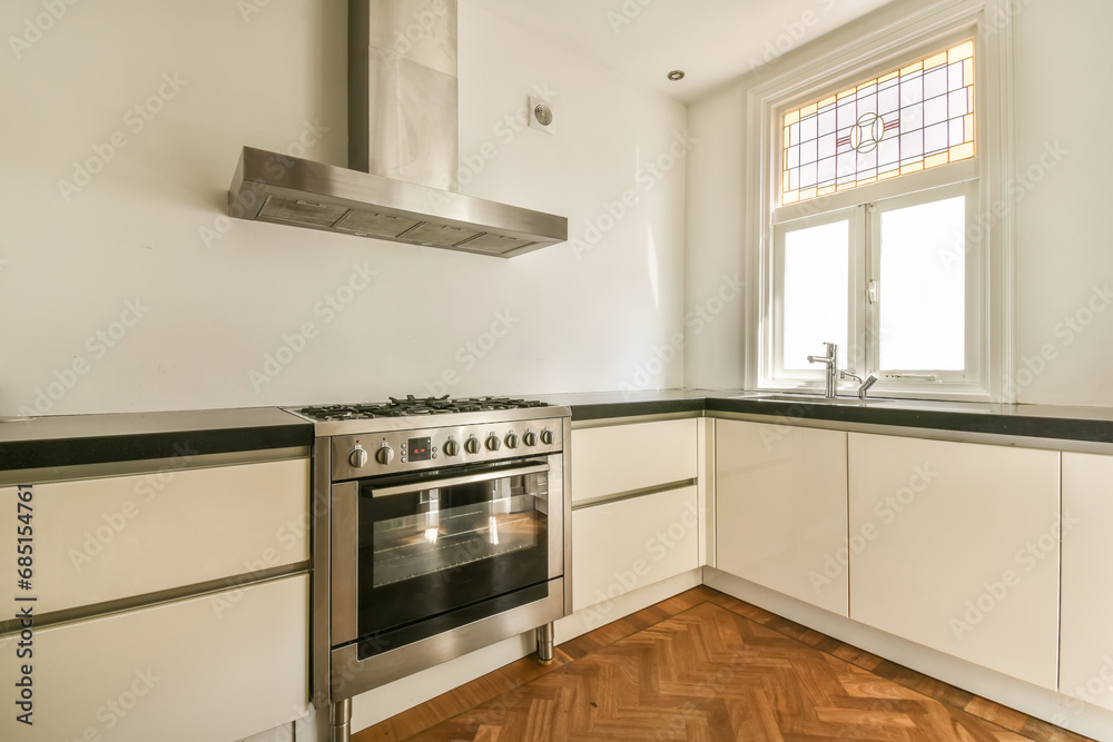 Kitchen with white cabinets and stainless steel oven Kitchen with white cabinets and stainless steel oven