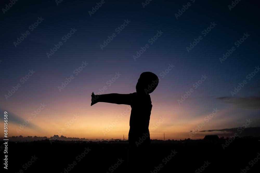 Silhouette photo at sunset with a beautiful sky background