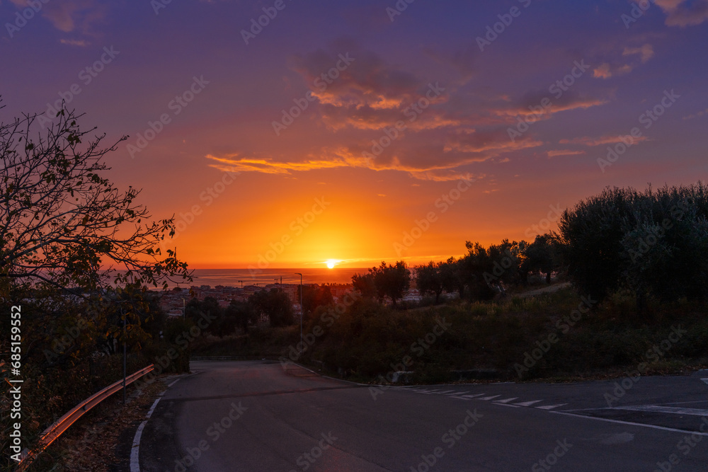 country road leading to Tortoreto on the Adriatic Sea in Abruzzo with a colourful sunrise sky