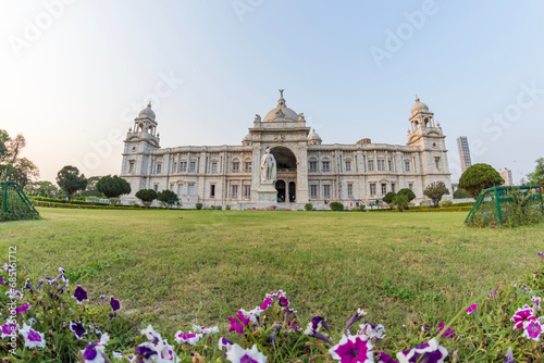 View of The famous Victoria Memorial with Garden, a large marble building in Central Kolkata, at the time of Sunrise. photo