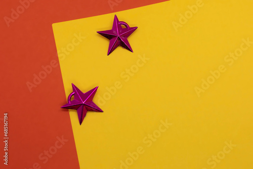 Christmas background with stars on a yellow and red background. Copy space © avs