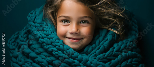 Close-up shot of a sweet girl with a turquoise blue scarf, creating an image of warmth and coziness in the enchanting winter magic.