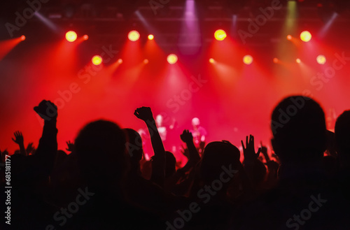 Concert crowd silhoutte. Large group of people partying on a music festival in bright red lights