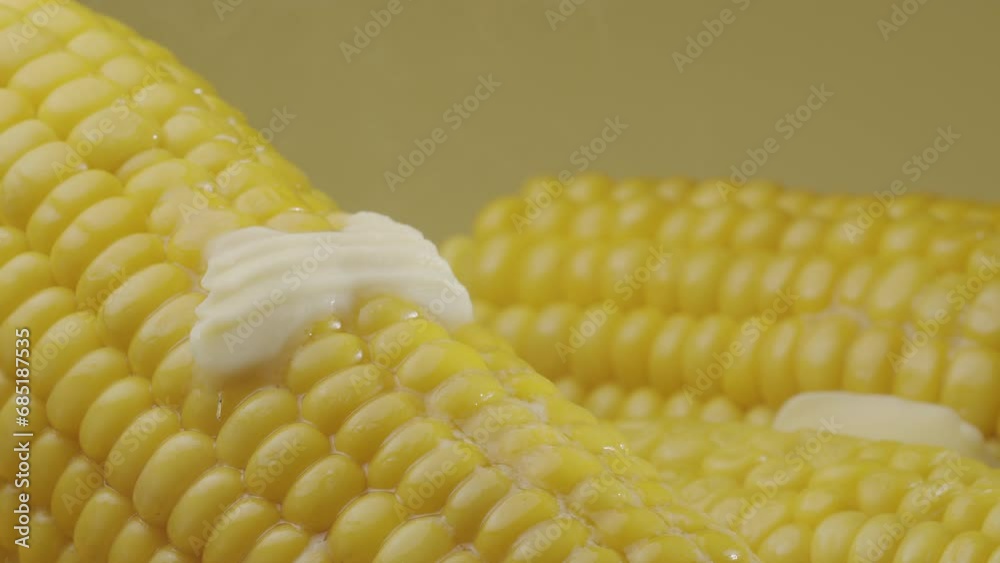 Piece of butter is slowly move along the ripe boiled cob of corn. Nice food background for your projects. Macro video shooting. Piece of butter is slowly move along the ripe boiled cob of corn. Nice food background for your projects. Macro video shooting.