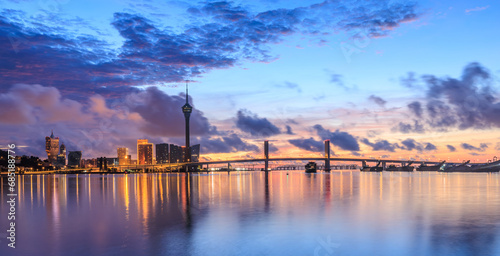 Macau city skyline and coastline scenery at sunset, China. Macau is located in the Pearl River Delta on the southeast coast of China.