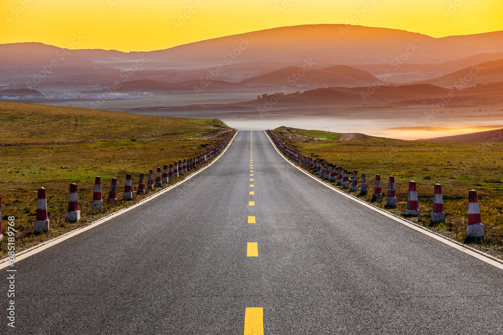 Asphalt highway road and mountain natural landscape at sunrise. Road and mountain background.