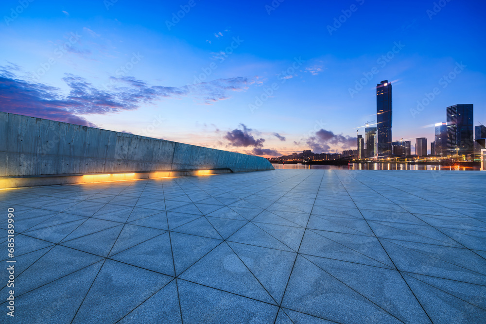 Empty square floor and skyline with modern buildings in Zhuhai at sunset, Guangdong Province, China. 