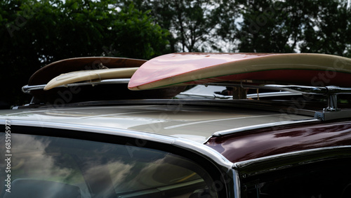 Surfboard on a vintage car roof