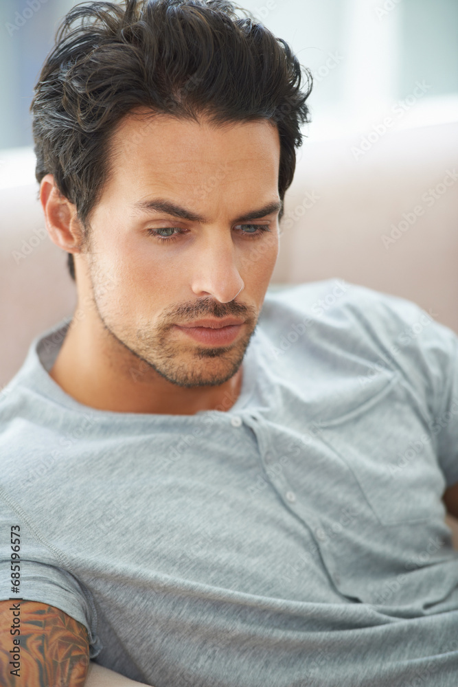 Fototapeta premium Man, thinking and sofa for problem in home or lonely grief mourning, broken heart or stress. Male person, unhappy thoughts on couch for depressed risk or sad loss from anxiety, mental health or fail