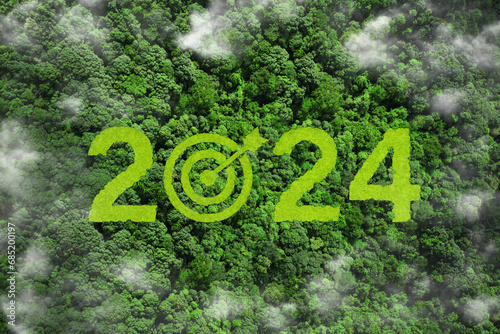  New Goals, Plans, and Visions for Next Year 2024. 2024 and target symbol on green grass in the forest.Sustainable environment development goals, analytical business planning business growth 2024, ESG photo