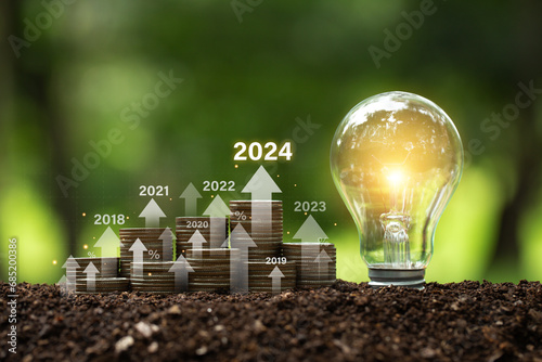 Stack of money with an arrow icon increasing future company growth 2024 planning opportunities challenges, saving and managing to success business,2024 Investment Environment target of Green business. photo