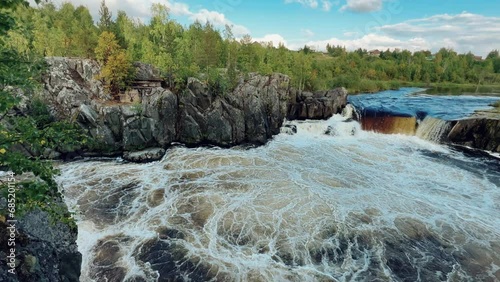 Voytsky padun waterfall in autumn. The famous powerful and wide Karelian waterfall Voytsky Padun is surrounded by rocks and greenery. Cascading waterfall on the river. Karelia, Russia 4K photo