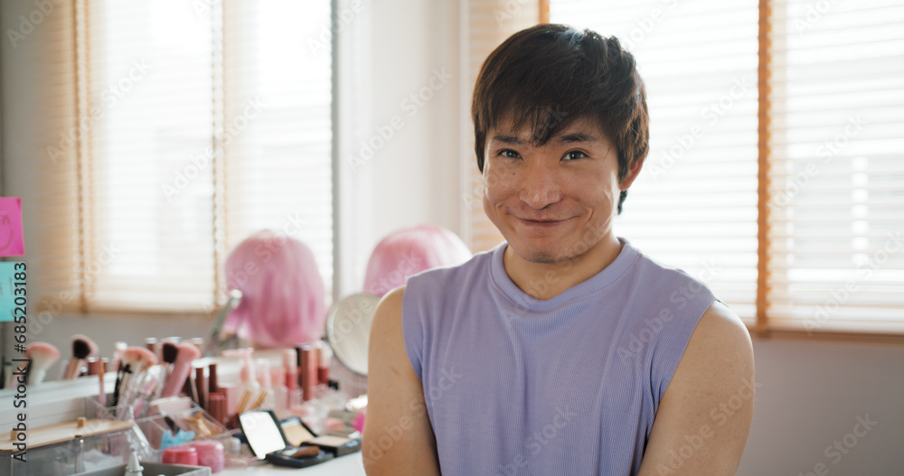 Gen Z Gay queer man non-binary beauty blogger makeup artist at home. Real asia LGBT young guy adult people happy relax smile sitting at mirror dressing room looking at camera proud and LGBTQ pride.