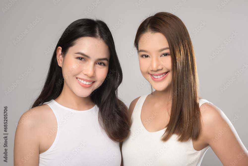 Two beautiful woman in white shirt over white background studio, skin care and beauty concept Two beautiful woman in white shirt over white background studio, skin care and beauty concept