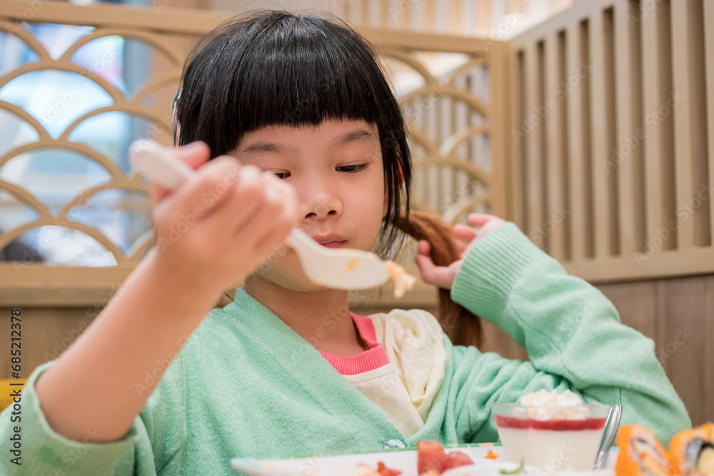 Cute little asian child girl eating food Cute little asian child girl eating food