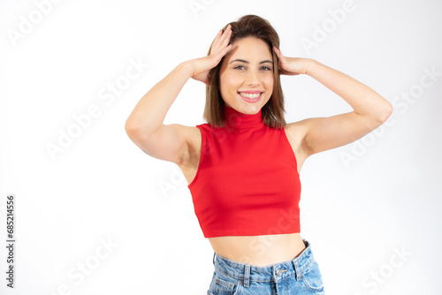 Close-up portrait of young pretty surprised woman with opened mouth standing with open palms, isolated over white background