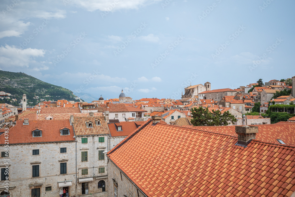 View to the red roofs of Dubrovnik Old town on cloudy summer day. 