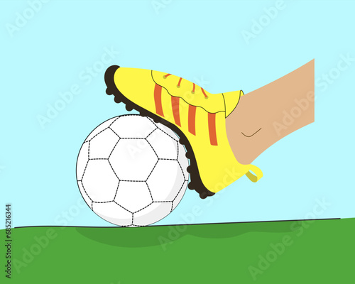 Foot in a football boot on a ball composition. Soccer player step on a ball laying on the stadium grass.
