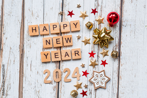 A postcard or banner.A symbol from the number 2024 with red Christmas tree toys, stars, sequins and a beautiful bokeh on a white wooden background. Happy New Year 2024.
