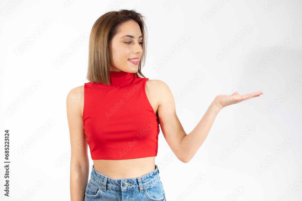 Happy woman presenting with open hand holding something blank isolated over white background Happy woman presenting with open hand holding something blank isolated over white background