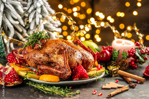 Christmas dinner, baked duck with oranges on a festive table. copy space for text photo