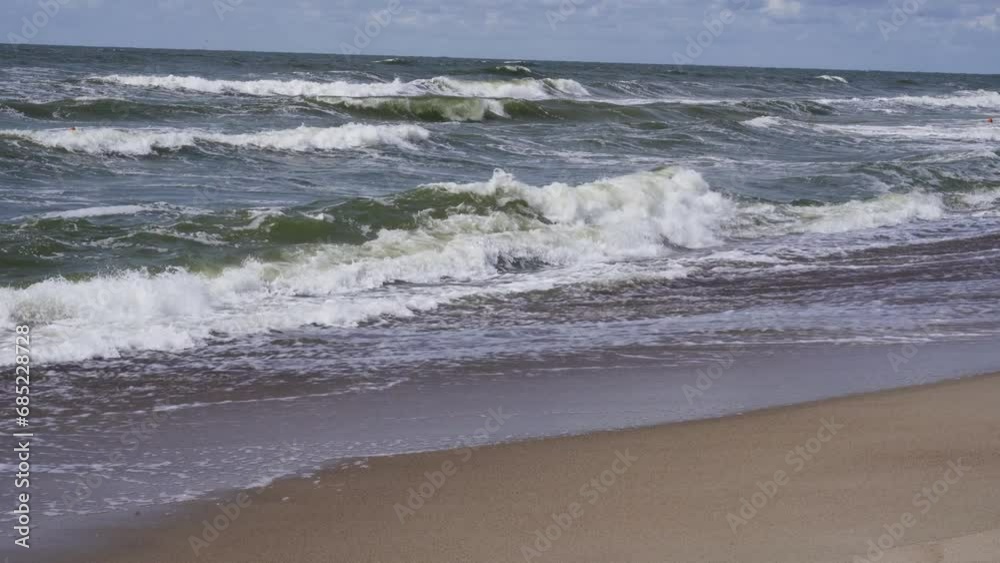 There is a strong wind and waves at sea, the waves wash away the sandy beach. There is a strong wind and waves at sea, the waves wash away the sandy beach.
