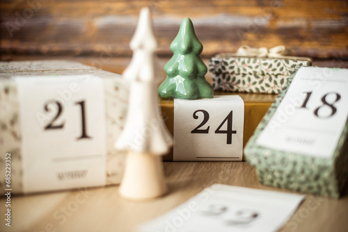 Gifts for an advent calendar next to Christmas decorations photo