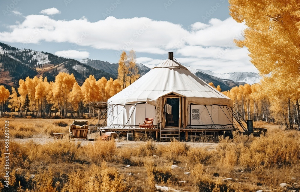 A white yurt in the highlands surrounded by immature poplar trees.