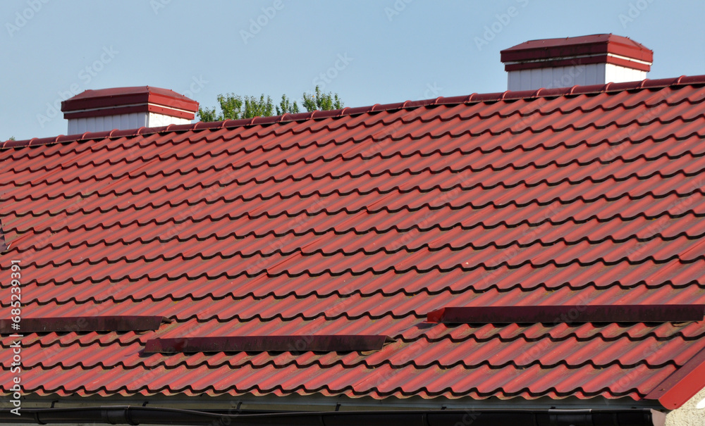 Fototapeta premium The roof of the house is covered with metal tiles