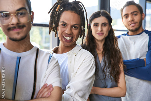 portrait of smiling african american team lead near multicultural colleagues in office, teamwork