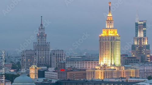 Evening close up view of Stalin skyscrapers and three railway stations day to night transition timelapse at the Komsomolskaya square in Moscow, Russia. Aerial view from rooftop. photo