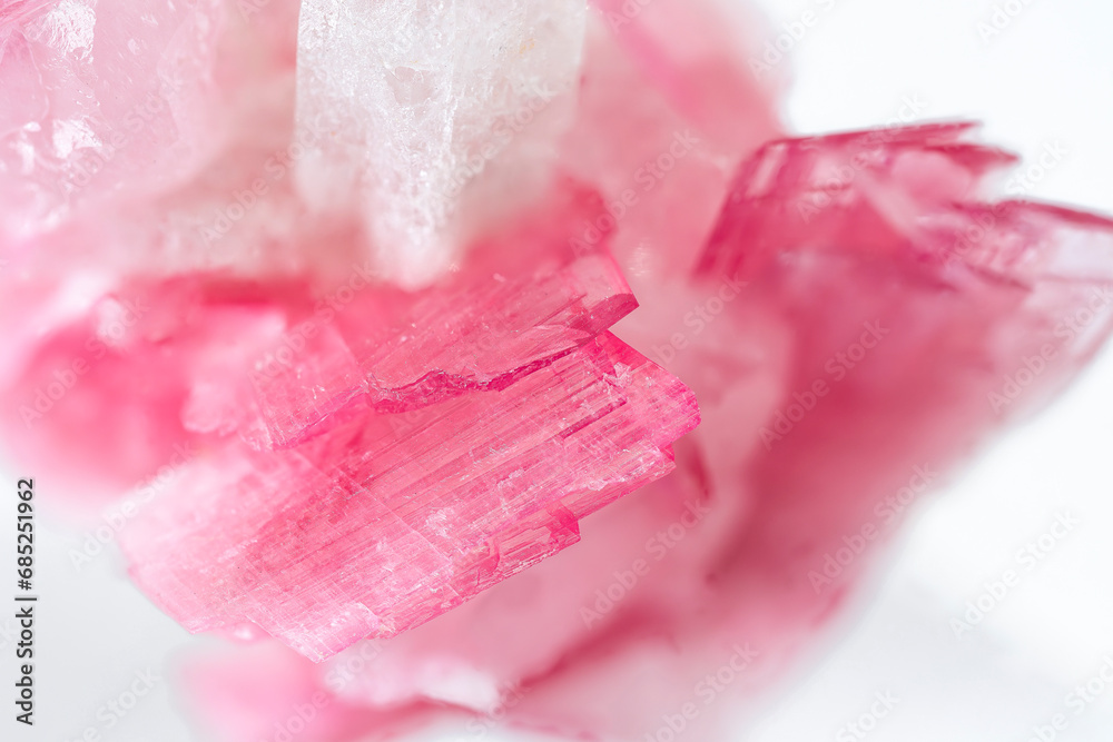 macro close up of natural rubellite (pink tourmaline) mineral cristals on white background macro close up of natural rubellite (pink tourmaline) mineral cristals on white background