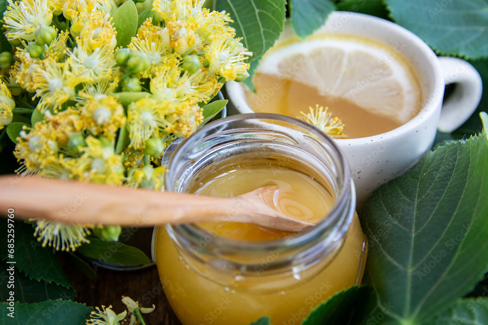 linden tree branch and inflorescence of linden flowers, cup of herbal