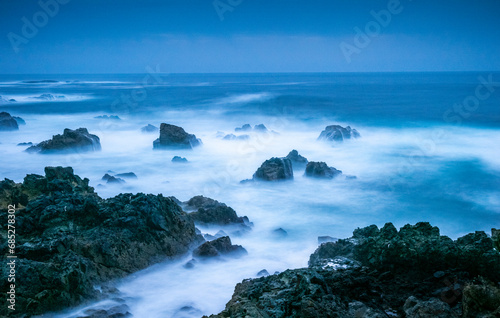 Dusk along the rocky shoreline of the Atlantic Ocean in the Costa Azul region of Portugal