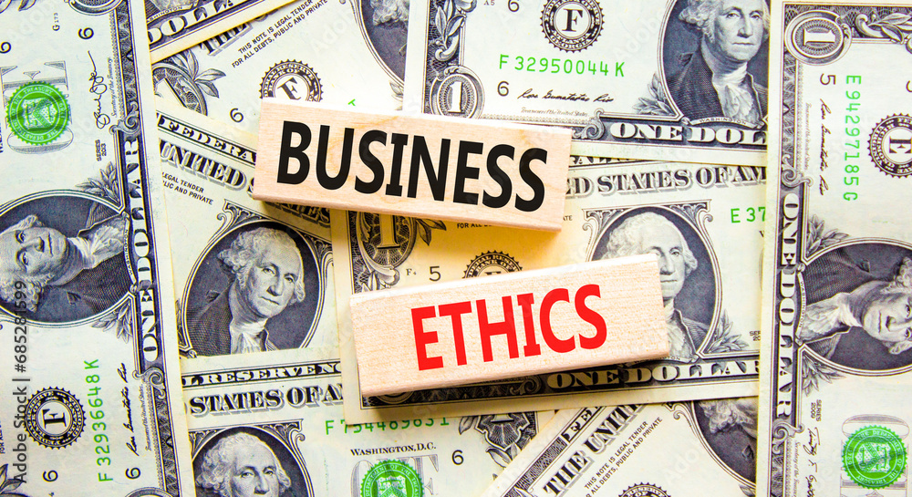 Business ethics symbol. Concept words Business ethics on beautiful wooden blocks. Dollar bills. Beautiful background from dollar bills. Business ethics concept. Copy space.