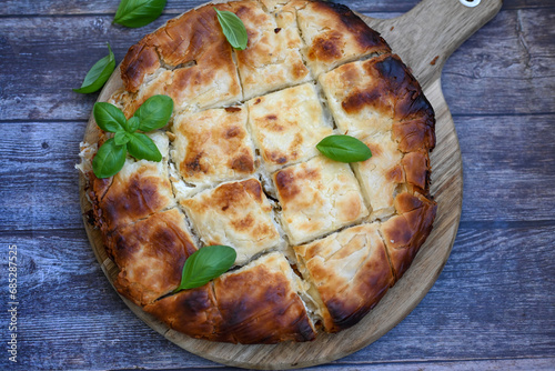 Bakery .Home made  cheese pie  with phyllo pastry and organic eggs. Bulgarian banitsa photo