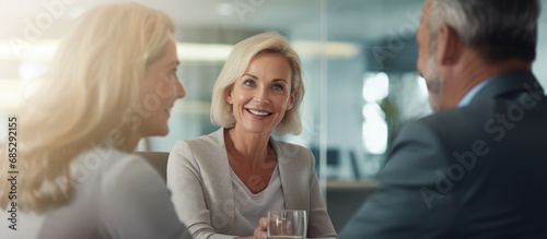 Mature couple meeting banker for investment listening to advisor copy space image