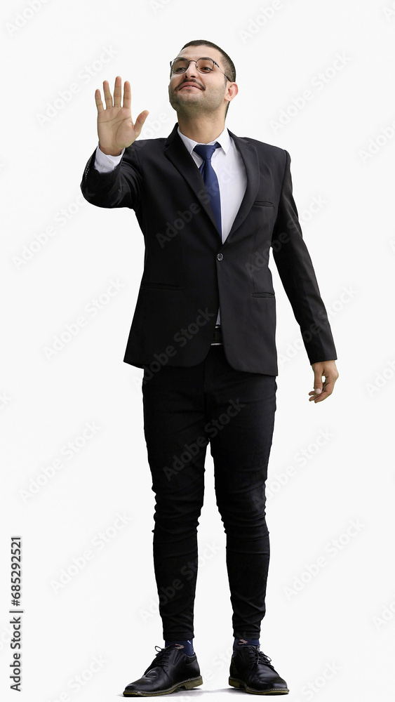 young man in full growth. isolated on white background shows hello with hand