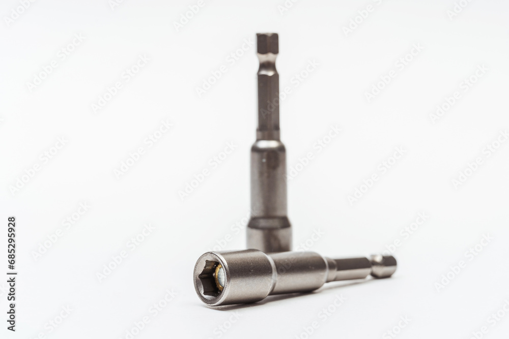 iron nozzle for roofing screws on a white background. metal adapter for screwing in self-tapping screws on a light background. reinforced bolt socket iron nozzle for roofing screws on a white background. metal adapter for screwing in self-tapping screws on a light background. reinforced bolt socket